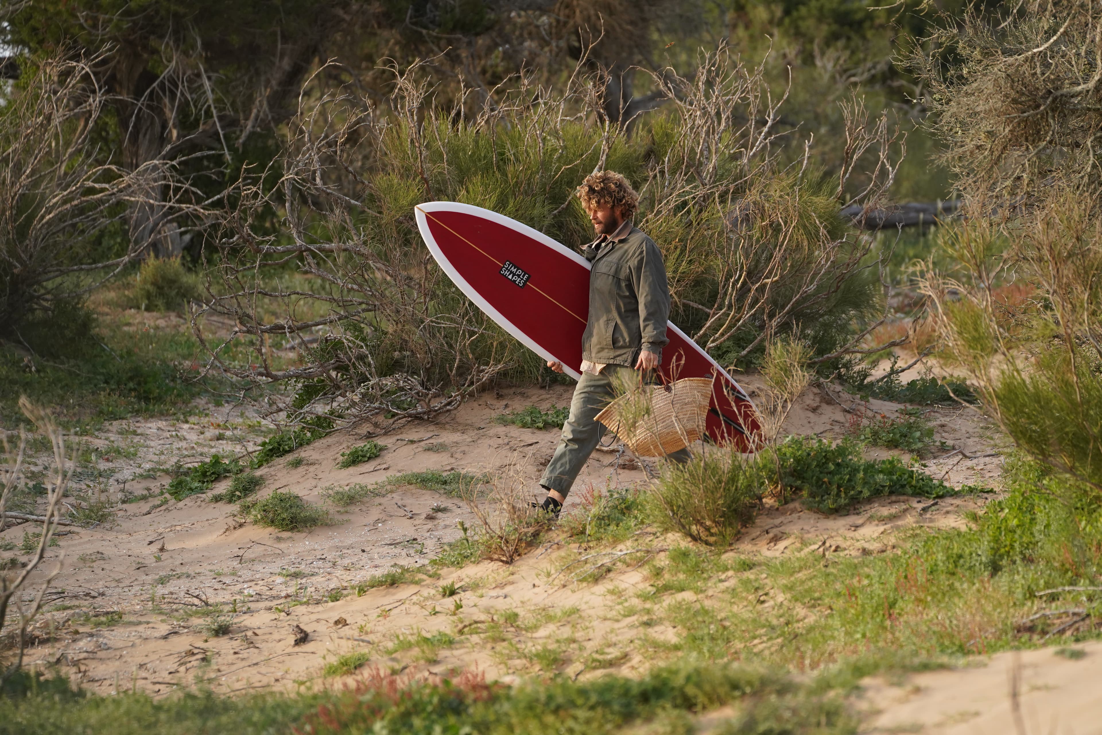A surfer on the coast near Cap Sim at the end of the day